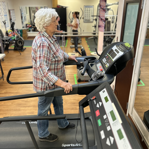 Female patient is walking on a treadmill