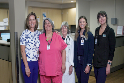 Five females smiling. One Physician and four nurses 